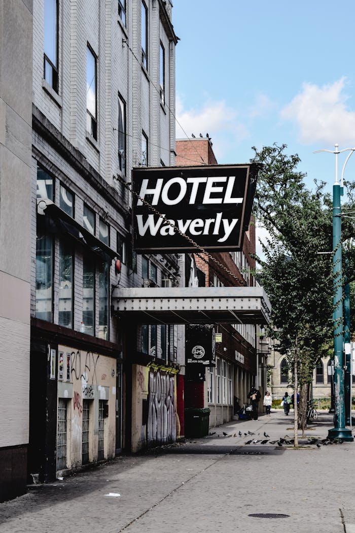 services-bg Street view of the historic Hotel Waverly facade in Toronto, showcasing urban architecture and vintage design.